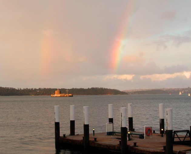 View of Sydney Harbour with Fort Denison framed by two Rainbows